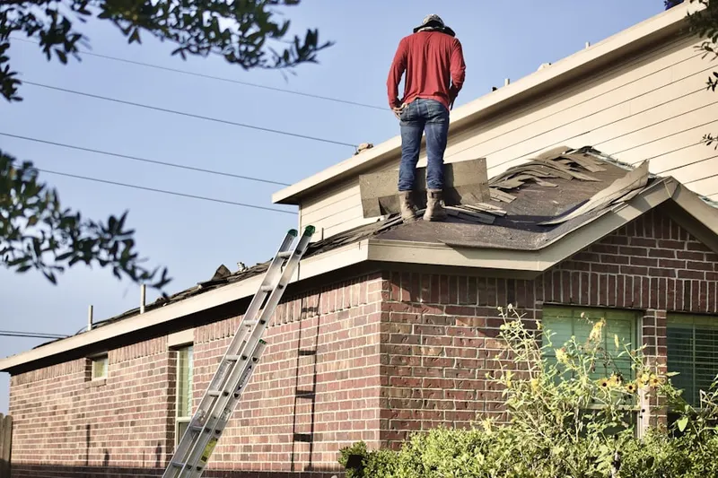 Professional roofer working on a residential roof in Laketown
